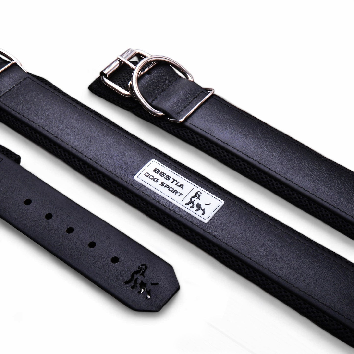Black leather dog collar with metal buckle and BESTIA DOG SPORT label, laid flat on white background.