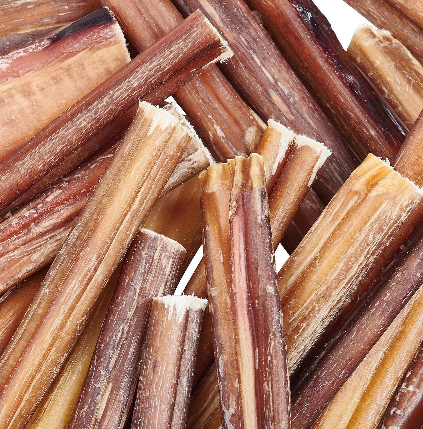 Dried bully sticks for dogs, stacked in a pile.