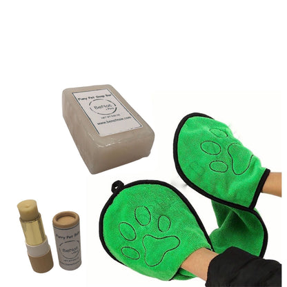 Green pet grooming mitts with paw prints and a soap bar.