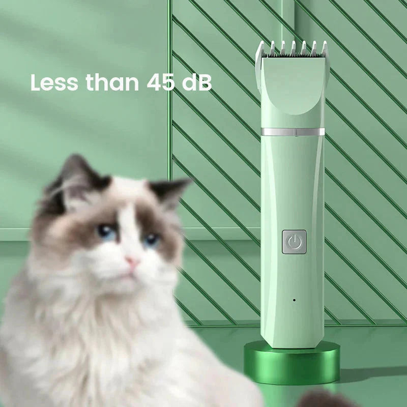 Green pet grooming clipper with a power button, shown next to a cat.