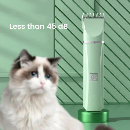 Green pet grooming clipper with a power button, shown next to a cat.